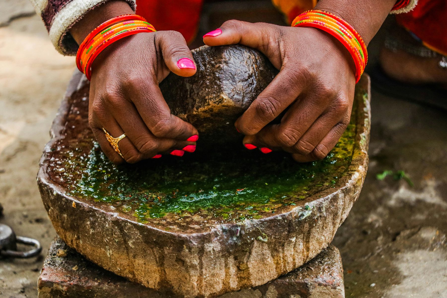 Hands preparing an Ayurvedic herbal formulation — the art of sacred skincare passed through generations